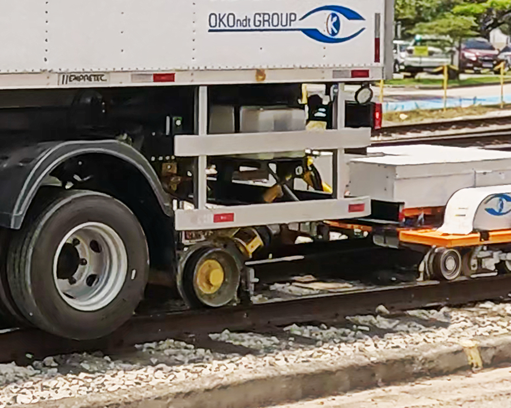Ultrasonic rail inspection system using dual immersion wheels for accurate defect scanning